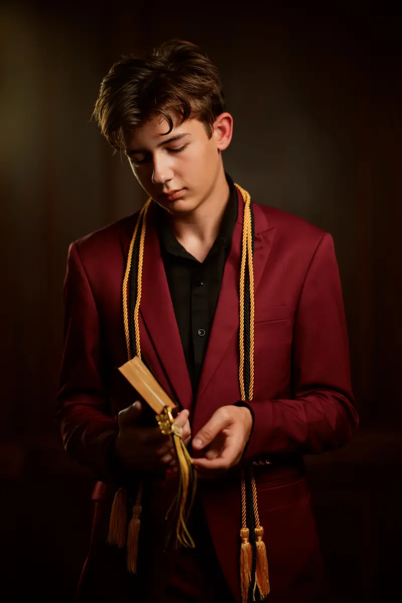 Editorial senior portrait with strong directional light