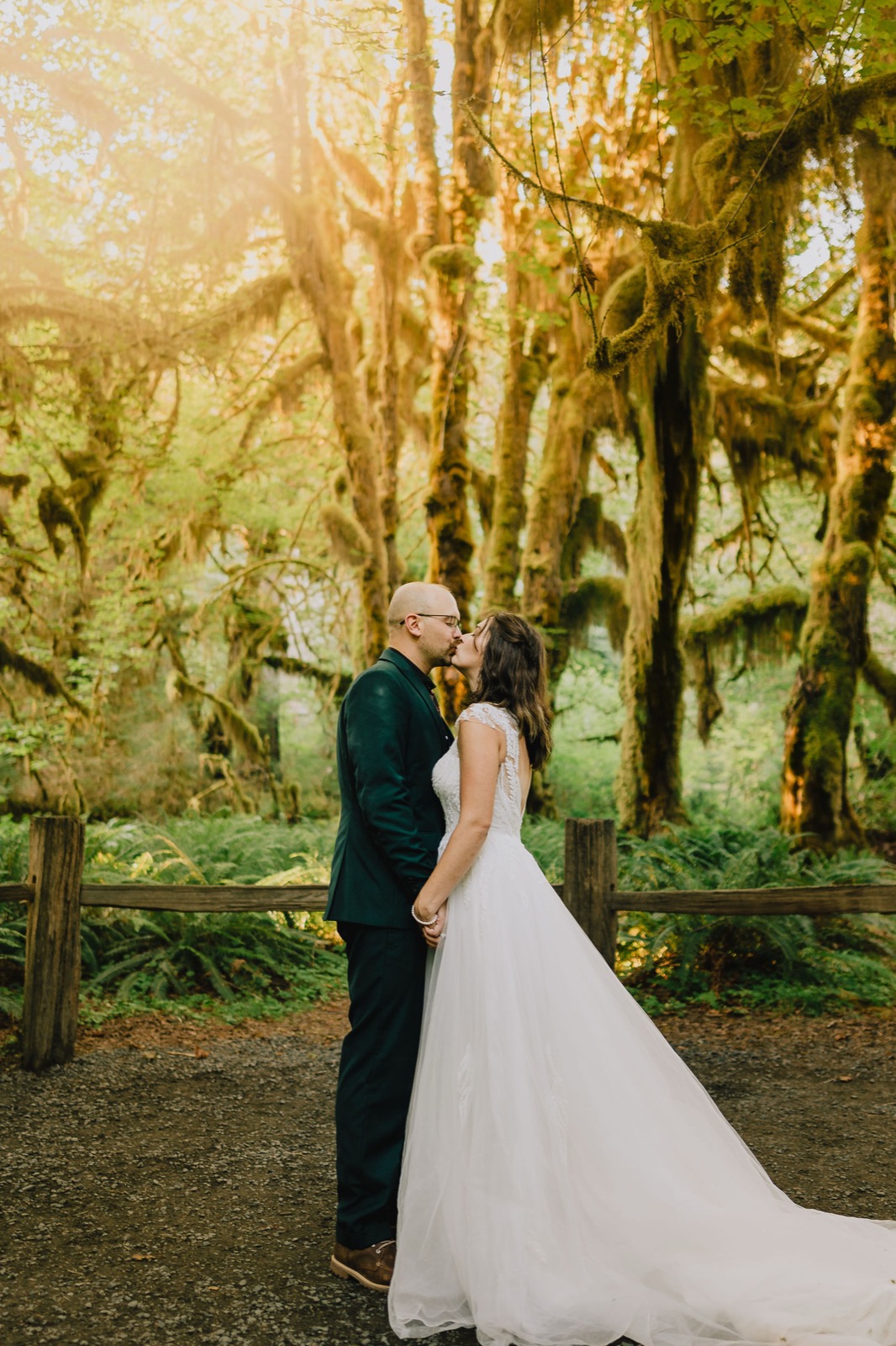 Bride twirling her dress in a shaft of green light in the Hoh Rainforest