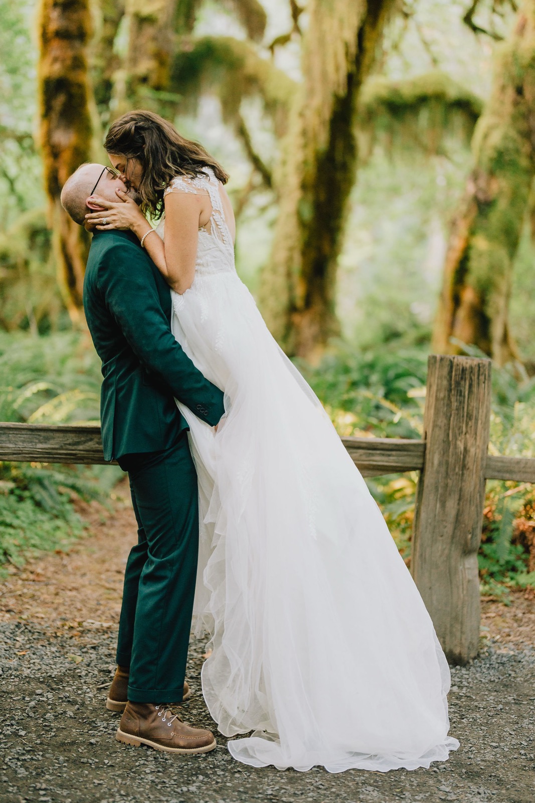 Adriana and Mitchell sharing a kiss surrounded by hanging moss on their Washington elopement day