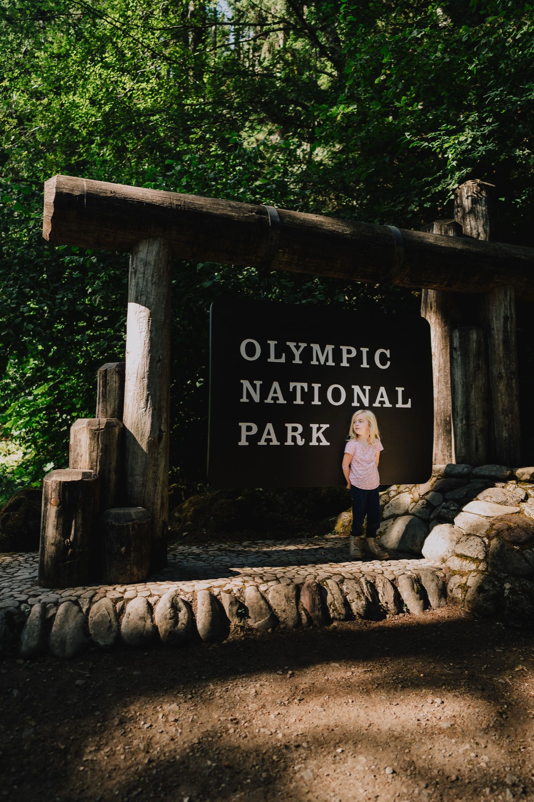 The couple at the Olympic National Park entrance sign in Washington State