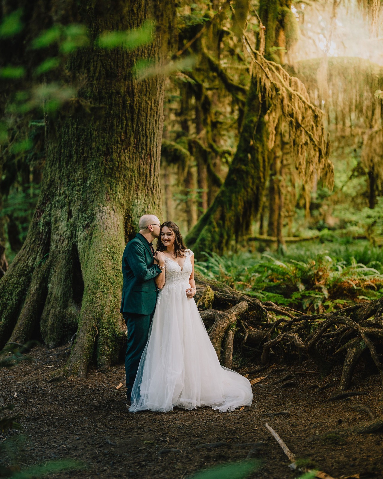 Couple embracing under draped moss in the Hall of Mosses
