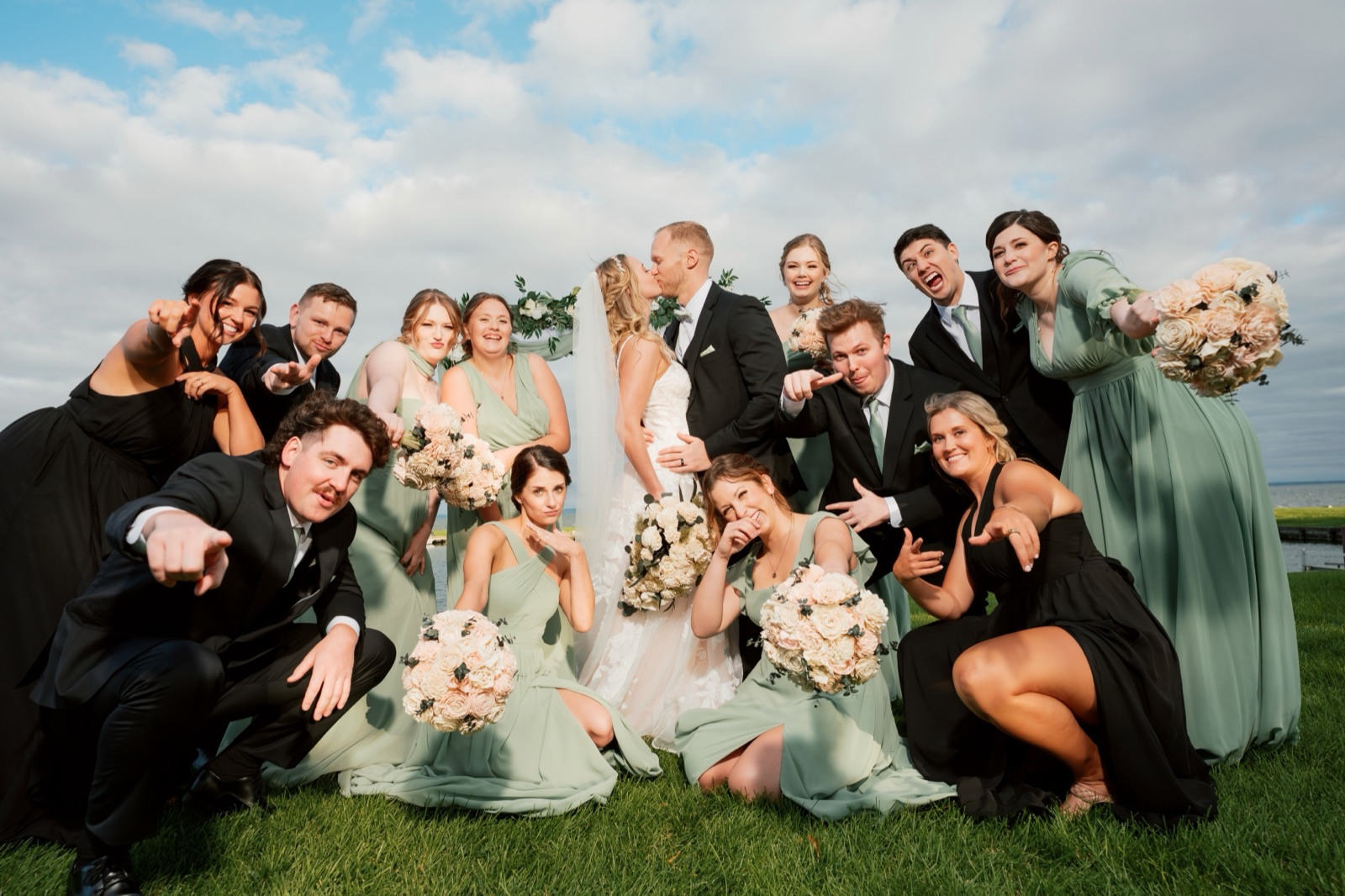 Wedding party celebrating around the couple